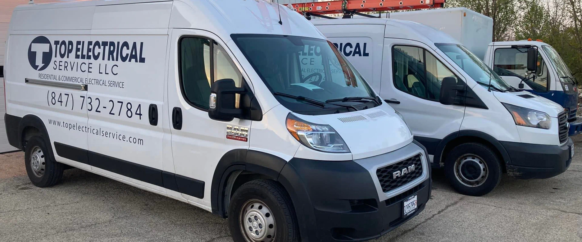 top electrical white vans with some orange stairs on top